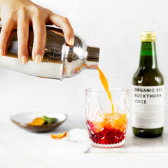 Erbology Sea Buckthorn Juice being poured into a glass for a vitamin boost