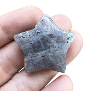 Fekuar Moonstone Star Palm Stone in hand for calm meditation and focus.
