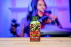 Gamer shot Apple Bash bottle close-up, 1.93 fl oz, on a desk.