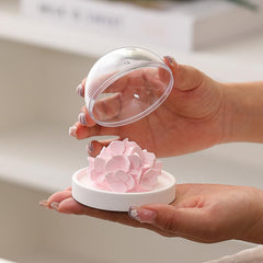 FLCSIed porcelain diffuser base with pink hydrangea bloom on a wood stand.