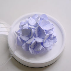 FLCSIed porcelain flower diffuser on natural wood base, perfect as desk decor.