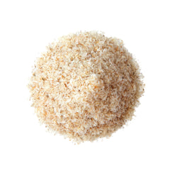 Food to Live psyllium husks poured into water, creating a thickening layer.