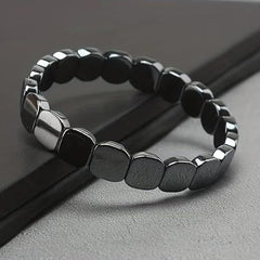 Fqwrus Hematite Bracelet – bead texture closeup emphasizing grounding energy for focus