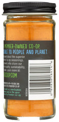 Frontier Co-op turmeric ground with measuring spoon, ideal for recipe prep.