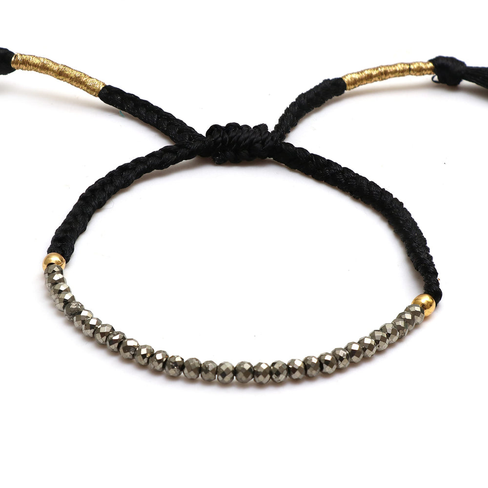 GEMPIRES pyrite bracelet close-up on braided string for everyday wear and subtle abundance energy