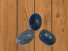 Gemscite Dumortierite palm stone in hand for portable relaxation