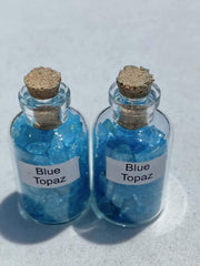 Generic Blue Topaz Crystal Mini Bottle shown among crystals for display.