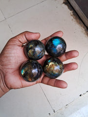 Close-up of Labradorite crystal ball highlighting natural sheen and texture.
