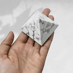 Generic natural Howlite pyramid on desk promotes focused, peaceful work.