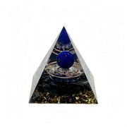 Generic orgone pyramid with amethyst and obsidian on a desk for positive energy.
