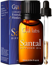 Gya Labs Santal diffuser oil bottle pour evokes warm sandalwood aroma for a cozy home.