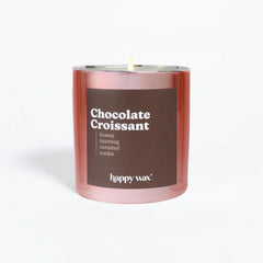 Happy Wax Chocolate Croissant candle in its jar, showcasing a warm bakery-inspired scent for cozy evenings.