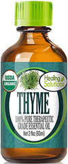 Healing Solutions Thyme Oil bottle close-up showing purity and organic quality.
