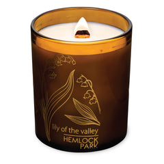 Hemlock Park wooden wick candle close-up showing warm glow and natural coconut wax