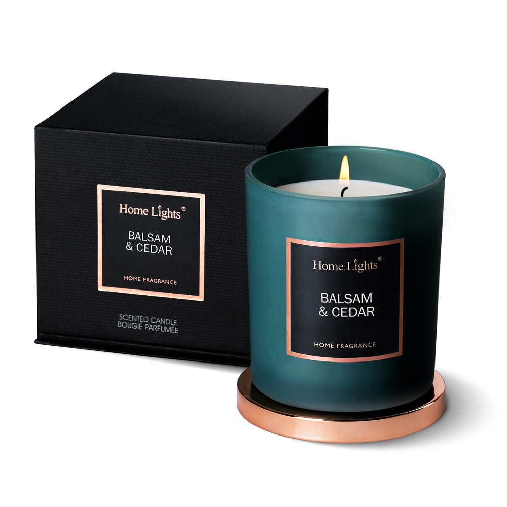 Home Lights scented soy candle in balsam-cedar jar for lasting woodsy ambiance.