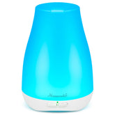 Homeweeks diffuser compact on a nightstand with soft ambient light and calm mist.