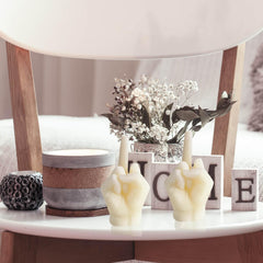 Hozodusi hand-gesture candle closeup showcases quirky decor with cozy vibes.