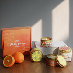 HUAN XI orange candles gift set four-pack on table, ready to enhance ambiance.