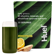 Huel Daily Greens Lemon & Ginger tub close-up with vibrant powder for daily nutrition