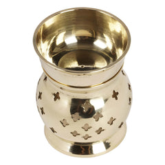 IBA Indianbeautifulart brass oil burner lit, adding soft light and scent to living spaces.