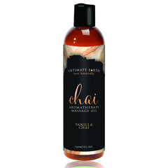 Intimate Earth Chai Vanilla massage oil bottle pour promotes sensual relaxation