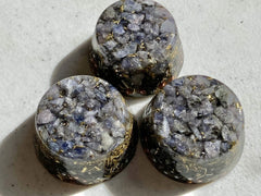 Iolite orgone generator placed beside electronics for calm room ambience