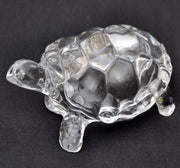 IS4A clear crystal turtle on a living room shelf promotes peace and prosperity.