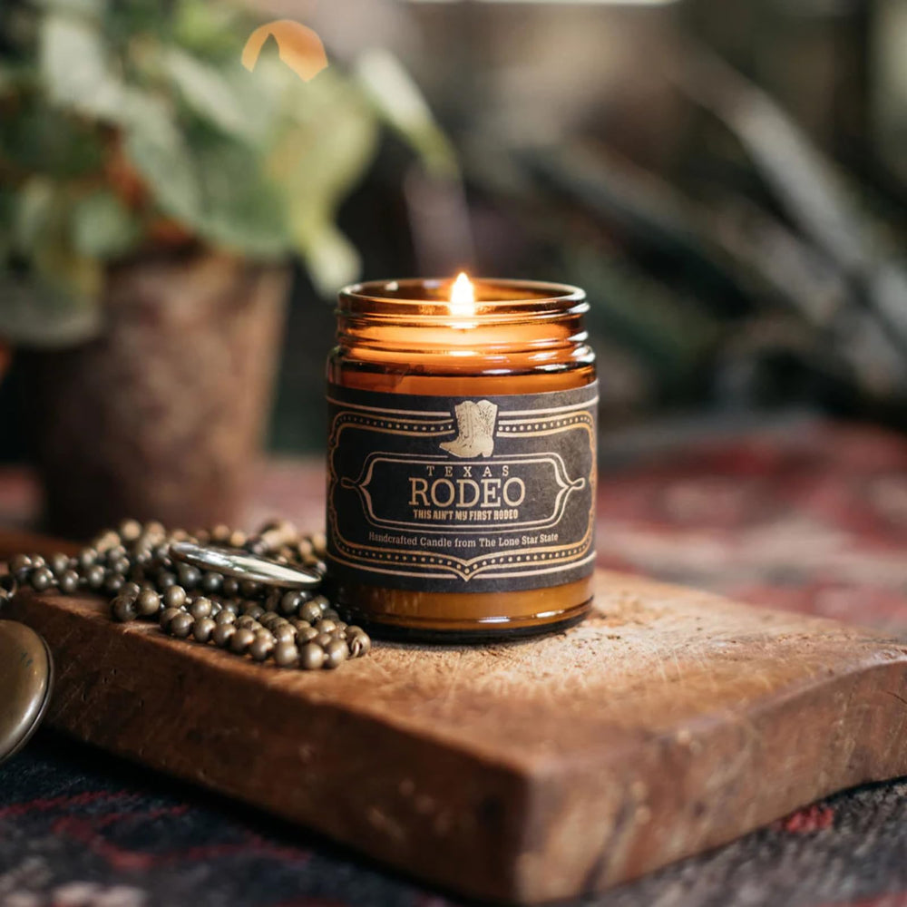 Jackson Vaughn Texas Rodeo 9oz candle jar with warm leather and spice aroma for living spaces.