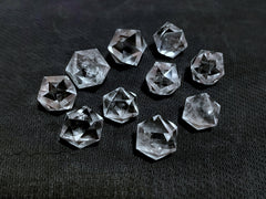 Jet International icosahedron pendant resting on an altar for focus.