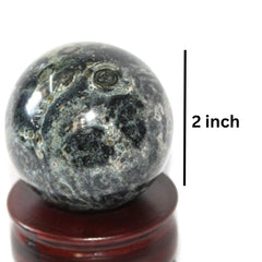 Jet International Kambaba Jasper sphere in hand demonstrates portable meditation companion.