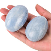 JIC Gem blue celestite palm stone held in hand for relaxation and balance.