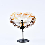 JIC Gem orange hematoid quartz heart with wings on stand for elegant desk decor.