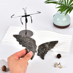 Silver stand displaying the crystal butterfly on a desk.