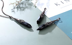 Bronze flower-wrapped Jovivi obsidian pendulum pendant detail for grounding and mindfulness.