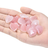 Jovivi rose quartz heart crystal in hand for meditation and calm energy.