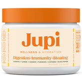Jupi Hydration & Wellness shot in glass shows turmeric-ginger blend for immune-support