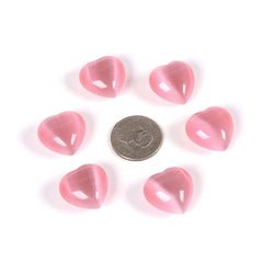 Justinstones pink cats-eye heart stones held in hand for gift-ready wellness decor.