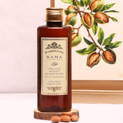 Kama Ayurveda organic almond oil bottle shown with natural ingredients.