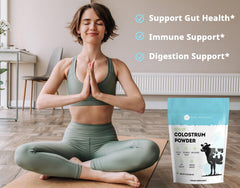 Scoop of Kate Naturals Colostrum Powder blending into water