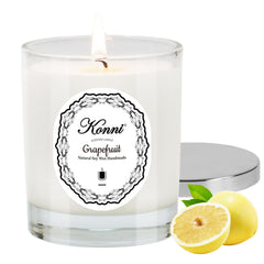 KONNI grapefruit scented candle jar glows softly, elevating any room with a bright citrus aroma