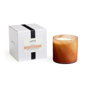 LAFCO New York Retreat candle in a hand-blown glass vessel enhances living room ambience.