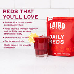 Laird Superfood Daily Reds powder scoop beside a ready drink for easy daily use.