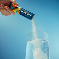 Liquid I.V. Hydration Multiplier Mango being poured into water for quick hydration