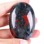 Loveliome bloodstone oval worry stone closeup showing polished surface and calm focus