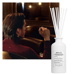 Maison Margiela Replica Jazz Club diffuser sticks inserted, releasing warm notes into the room.