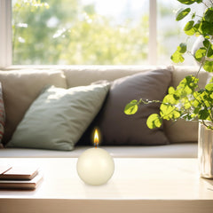 Mega Candles ivory ball candle in glass jar offers elegant decorative glow.