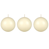 Mega Candles ivory ball candle on table creates warm ambience for dining.