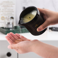 MELONY Massage Candle being poured onto skin to moisturize and soften