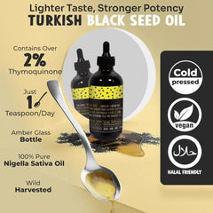 Pouring MerryTes Advanced Black Seed Oil into a teaspoon for daily use.