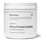 Momentous Essential grass-fed whey bottle pouring, smooth protein for post-workout recovery.